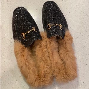 Black furry glitter mules.